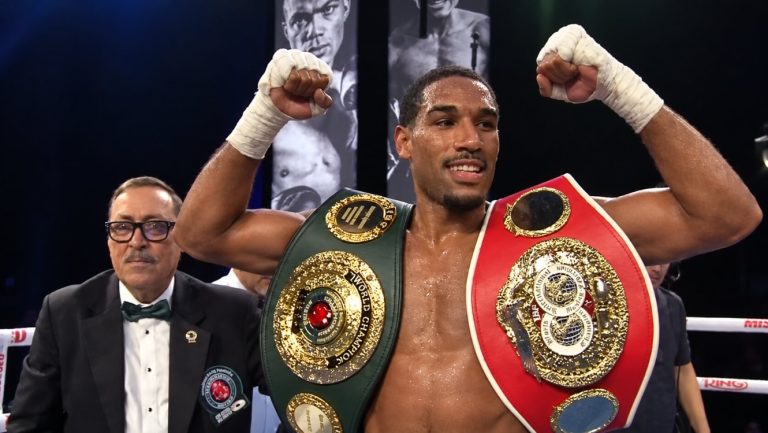 Osleys-Iglesias-celebrates-with-two-championship-belts.jpg