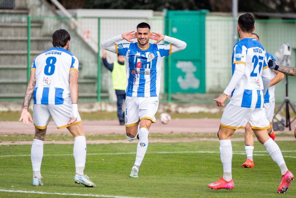 footballers-striped-shirts-celebrate-goal.jpg