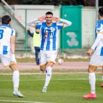 footballers-striped-shirts-celebrate-goal.jpg